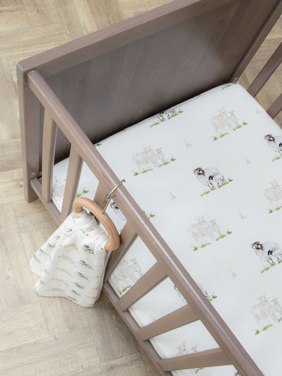 Sheep Lamb organic cotton cot bed sheet for baby and toddler displayed in cot by The Little Stamford Co